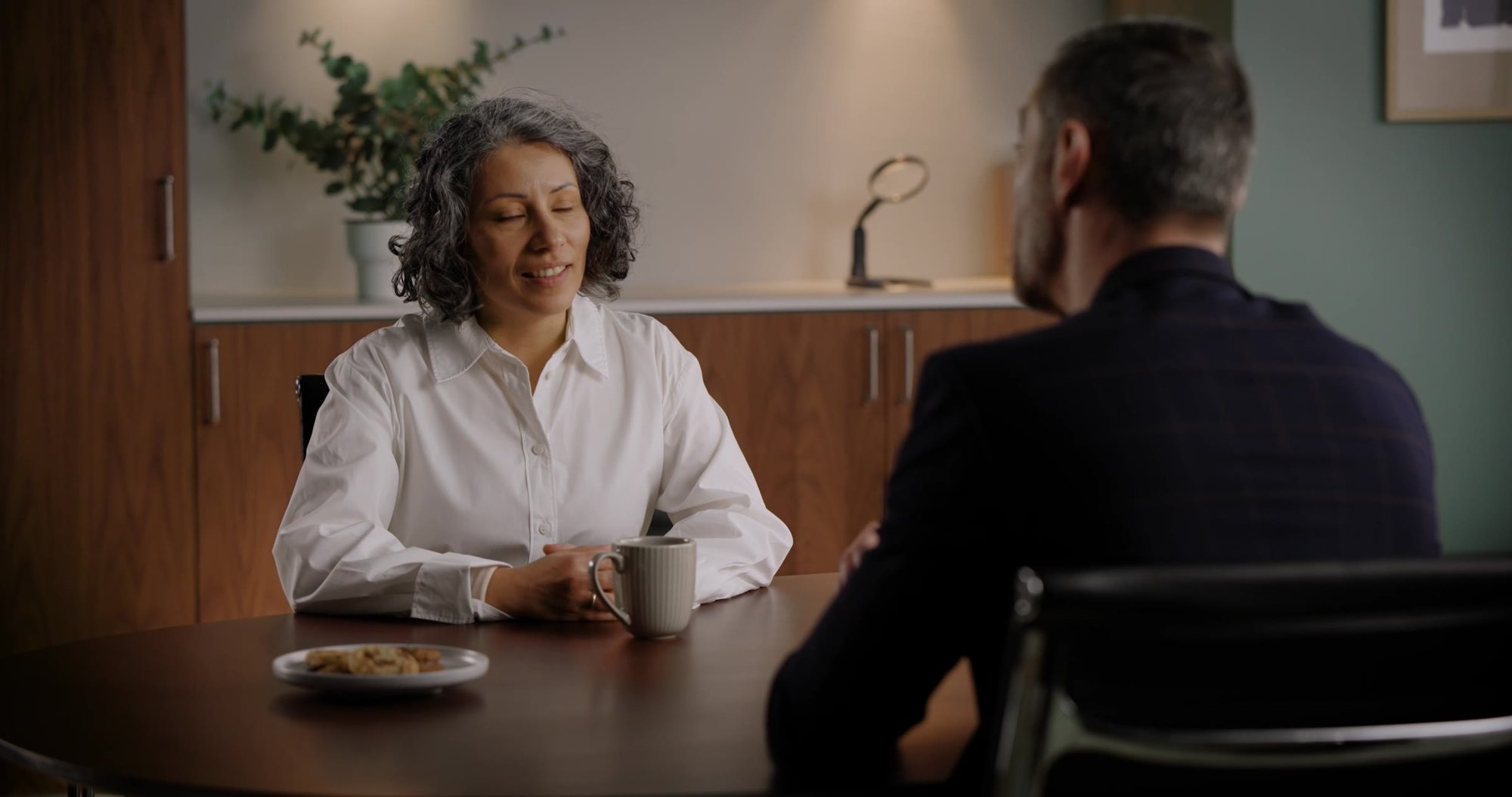 A client discussing hearing care with a professional