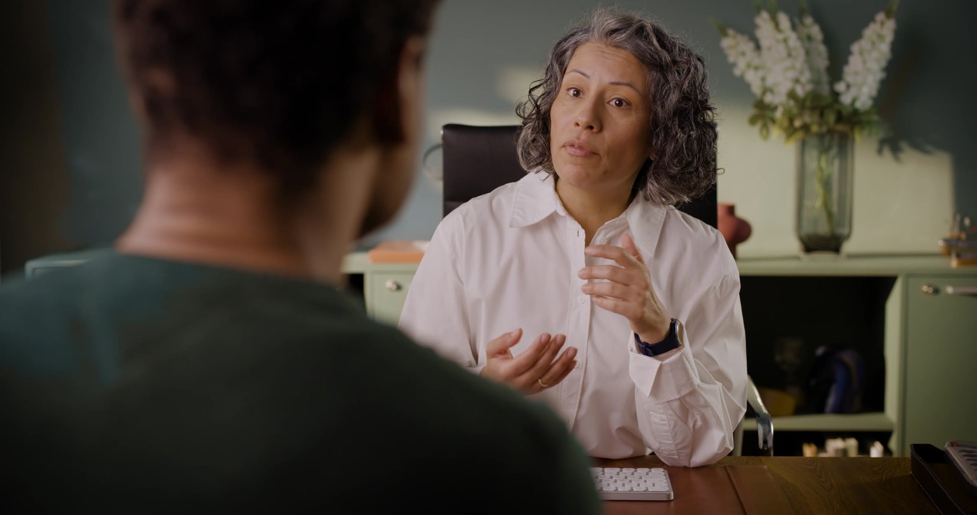 A hearing care professional explaining results to a client
