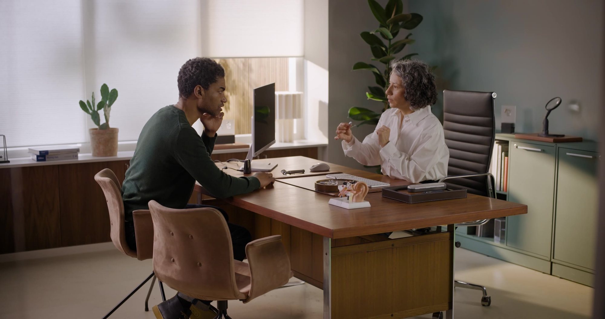 A client and a hearing care professional at a consultation desk