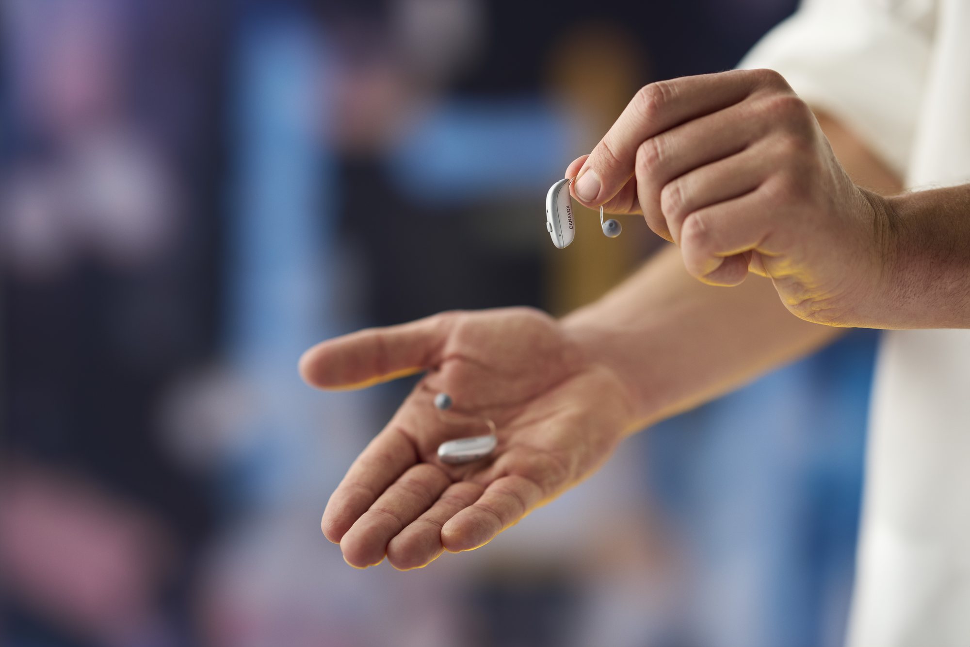 Holding a pair of Danavox hearing aids
